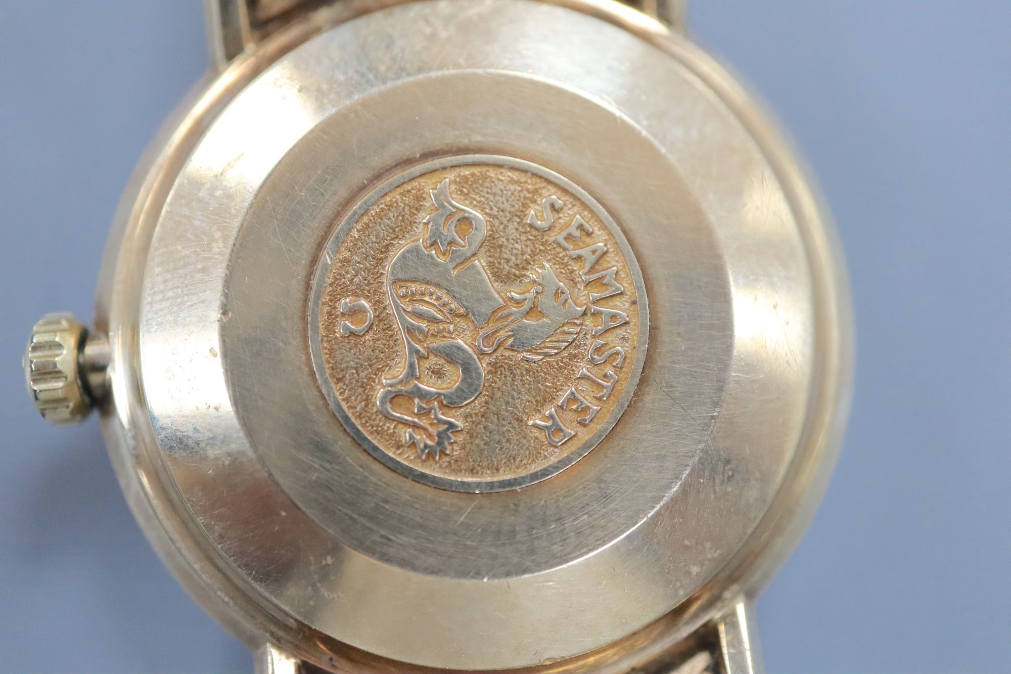A gentlemans early 1970s 9ct gold Omega De Ville automatic wrist watch, on integral Omega 9ct gold bracelet,